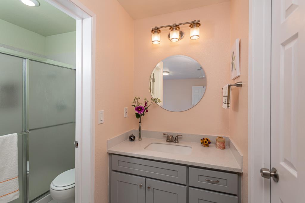 93 Shaniko Common, Unit 24 Fremont, CA 94539 - Photo 14 of 25 a bathroom with a toilet sink vanity granite and mirror