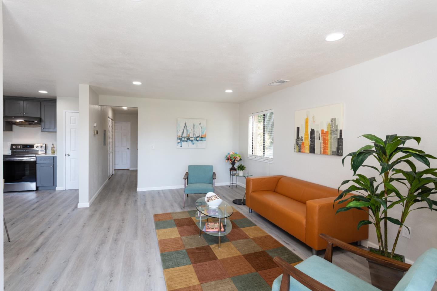 93 Shaniko Common, Unit 24 Fremont, CA 94539 - Photo 4 of 25 a living room with furniture and wooden floor
