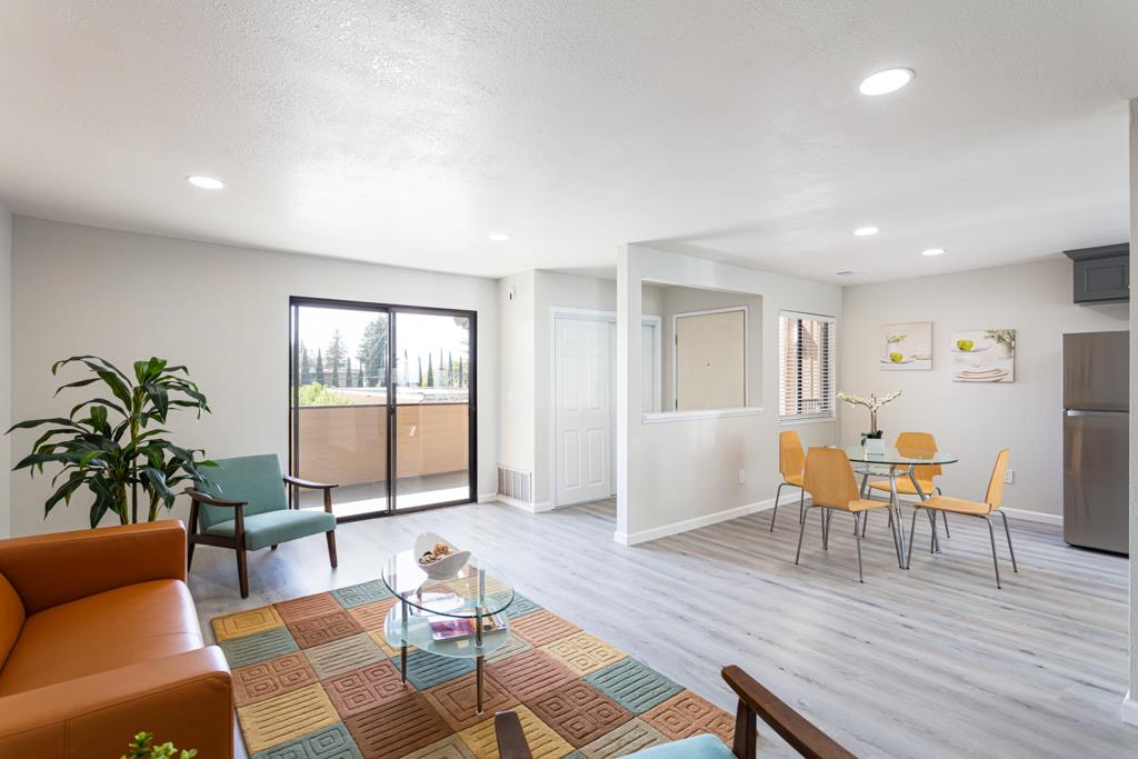 93 Shaniko Common, Unit 24 Fremont, CA 94539 - Photo 6 of 25 a living room with furniture a wooden floor and a potted plant