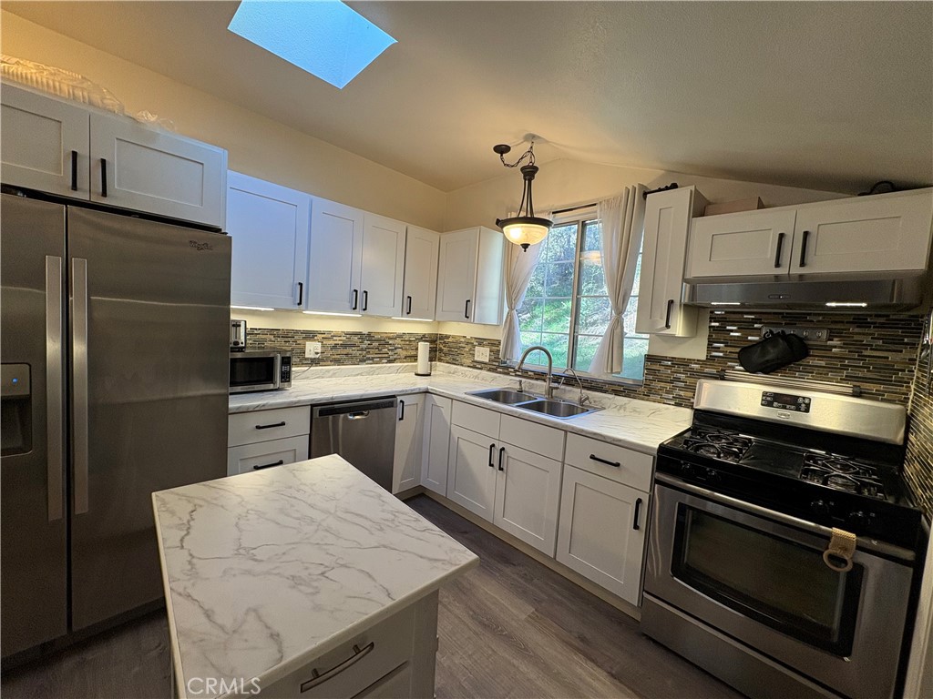 36750 Hilltop Road Yucaipa, CA 92399 - Photo 9 of 27 a kitchen with a sink stove and refrigerator