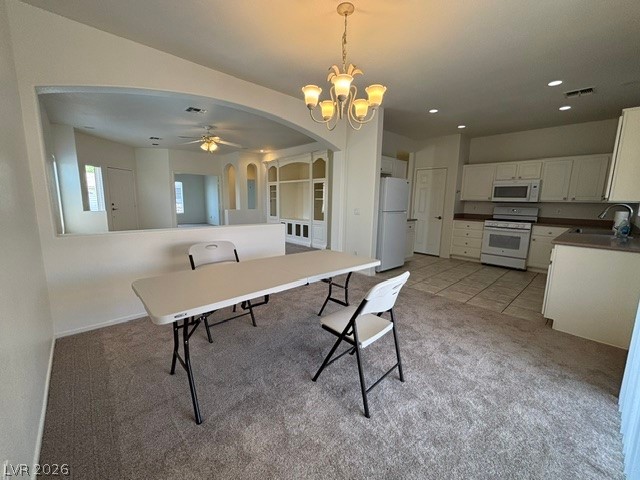 2866 Shimmering Bay Street Laughlin, NV 89029 - Photo 31 of 32 An open floorplan seamlessly connects the dining area with a functional kitchen.