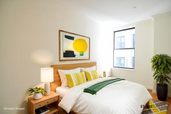 a bedroom with a bed and a window