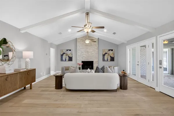 a living room with furniture a fireplace and a chandelier