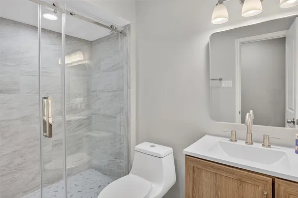 a bathroom with a sink toilet and shower