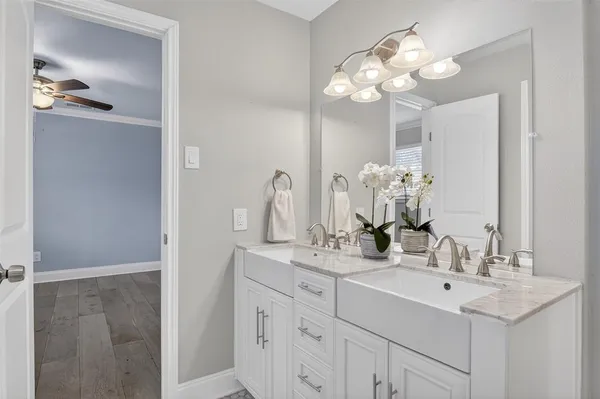a bathroom with a sink vanity and a mirror