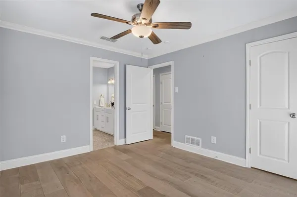 an empty room with fan and a ceiling fan