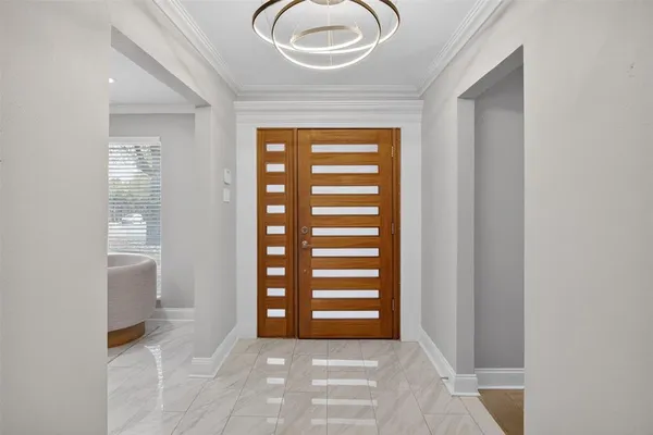 a view of a room that has a door and a window