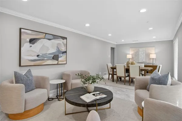 a living room with furniture and a view of kitchen