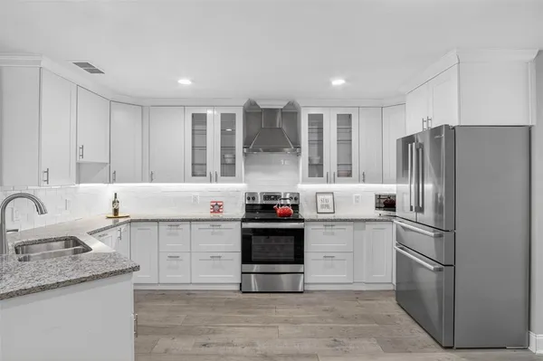 a kitchen with a sink stainless steel appliances and cabinets