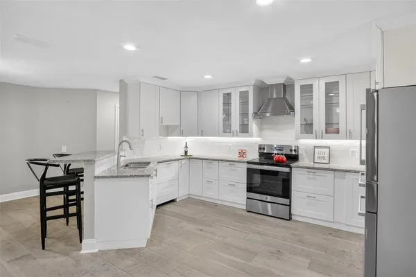 a kitchen with white cabinets and white appliances