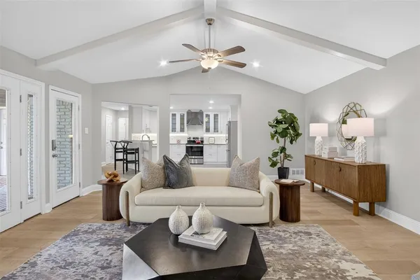 a living room with furniture potted plant and a chandelier
