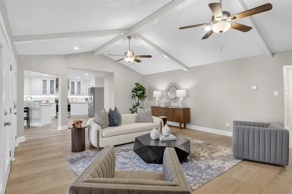 a living room with furniture and wooden floor