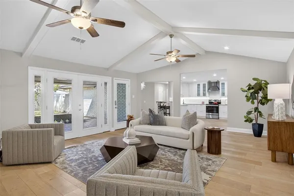 a living room with furniture and kitchen view