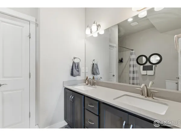 a bathroom with a double vanity sink and a mirror
