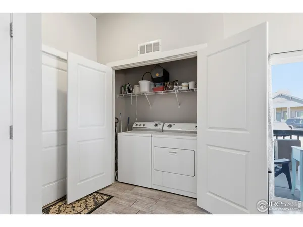 a utility room with cabinets washer and dryer