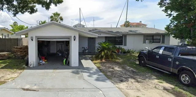 a view of a house with a patio and a yard