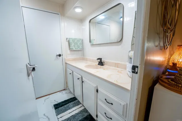 a bathroom with a double vanity sink and mirror