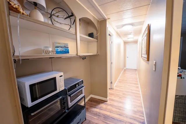 a view of room with wooden floor cabinet and flat screen tv