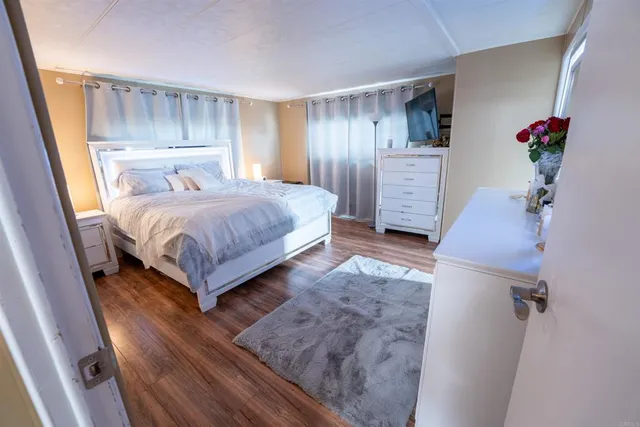 a bedroom with a bed and a television