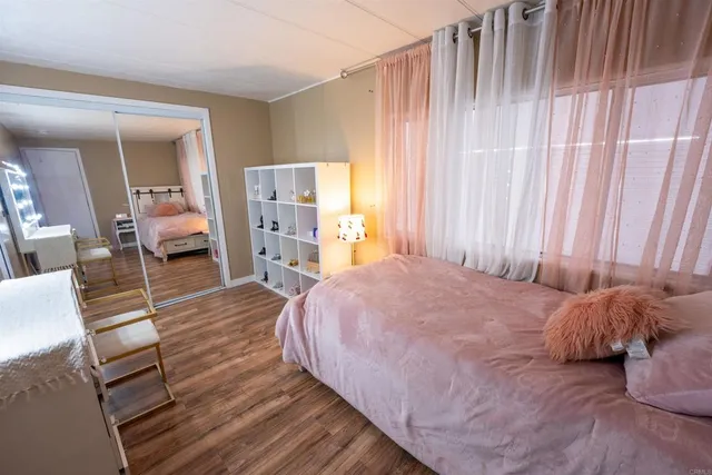 a view of a bedroom with baby crib and lounge chair