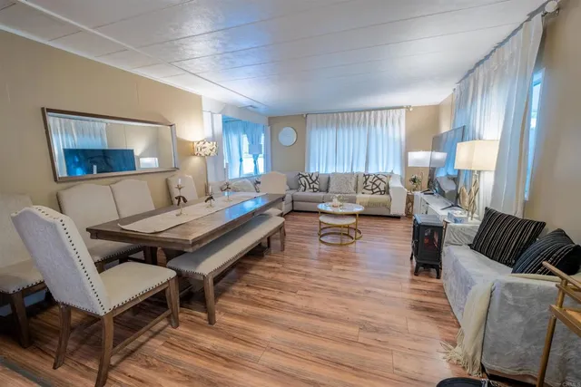 a living room with furniture a fireplace and a table