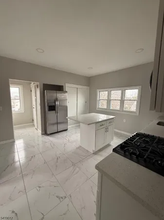 a kitchen with a stove a sink and a refrigerator