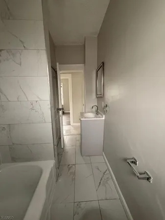 a bathroom with a sink a toilet and bathtub