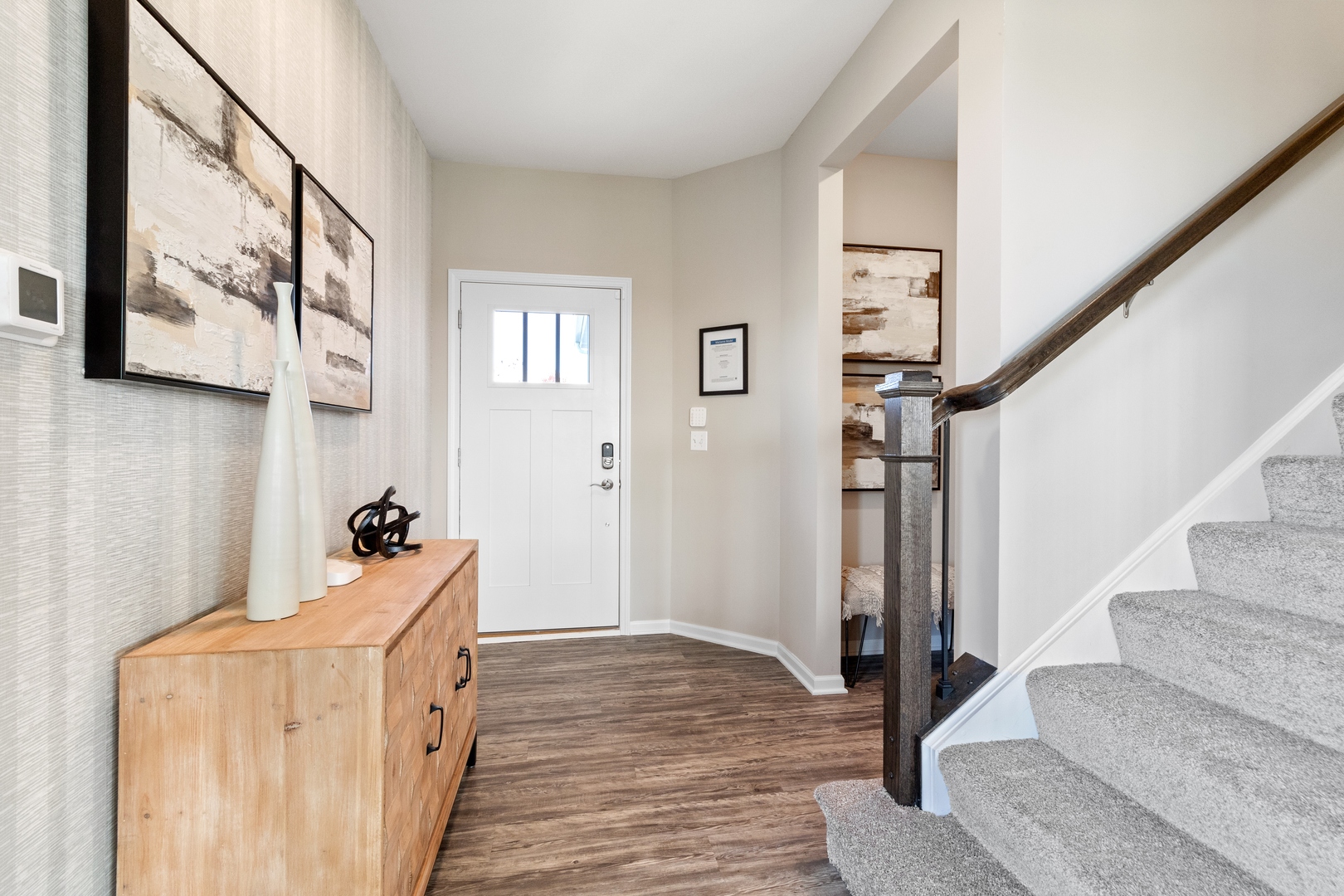 25626 West Springview Drive Plainfield, IL 60586 - Photo 2 of 27 a room with lots of white furniture and stairs