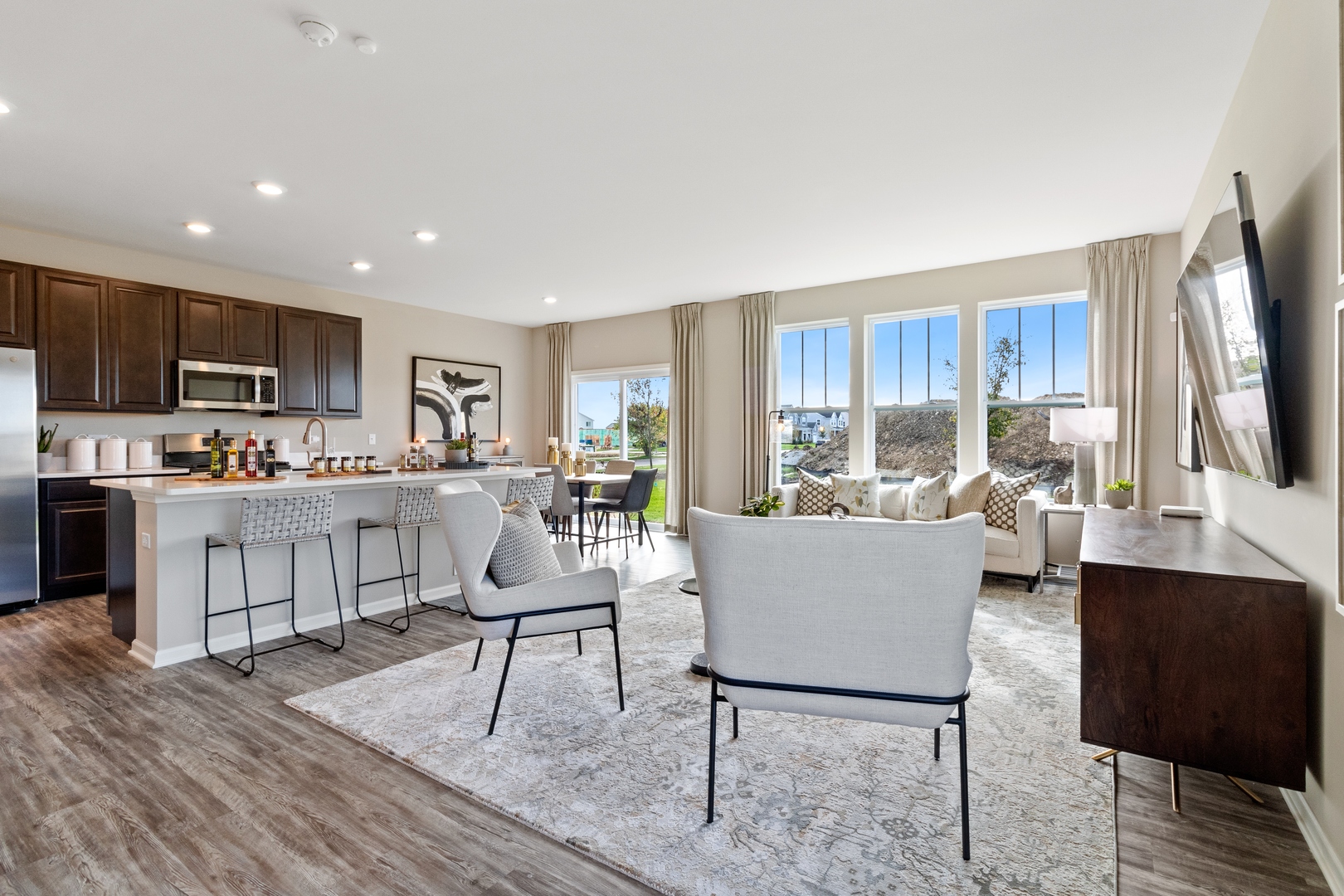 25626 West Springview Drive Plainfield, IL 60586 - Photo 3 of 27 a living room with kitchen furniture and a kitchen view