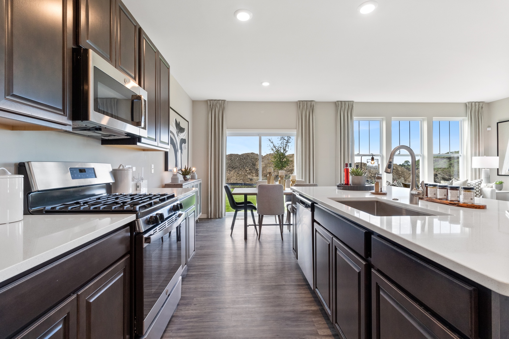 25626 West Springview Drive Plainfield, IL 60586 - Photo 7 of 27 a kitchen with stainless steel appliances granite countertop sink stove top oven and cabinets