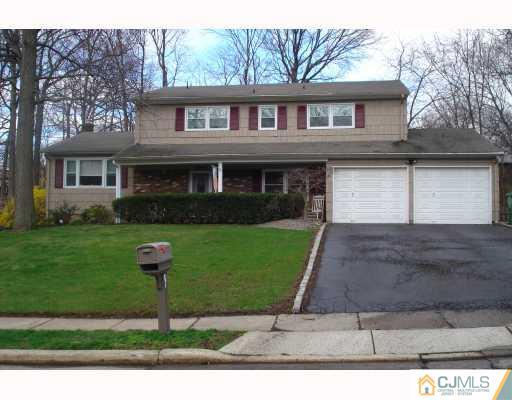 15 Lynnwood Road Edison, NJ 08820 - Photo 1 of 9 a front view of a house with a garden and plants