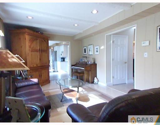 15 Lynnwood Road Edison, NJ 08820 - Photo 5 of 9 a bedroom with furniture and a chandelier