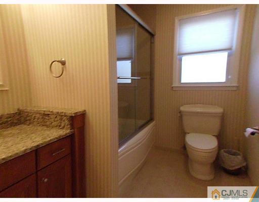 15 Lynnwood Road Edison, NJ 08820 - Photo 7 of 9 a bathroom with a granite countertop toilet and a sink