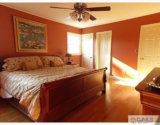15 Lynnwood Road Edison, NJ 08820 - Photo 8 of 9 a bedroom with a bed and wooden floor