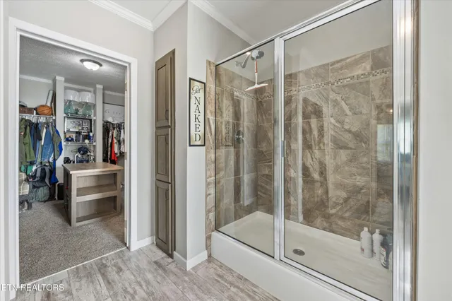 a view of walk in closet with clothes and shoes