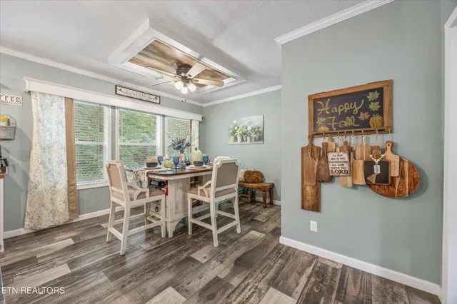 a dining room with furniture a chandelier and wooden floor