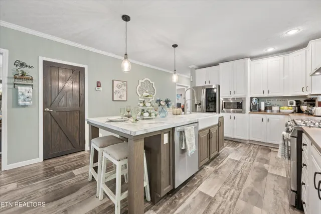 a large kitchen with a table and chairs