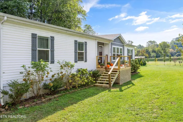 a view of a house with backyard porch and sitting area