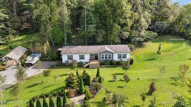 an aerial view of a house with yard swimming pool and outdoor seating