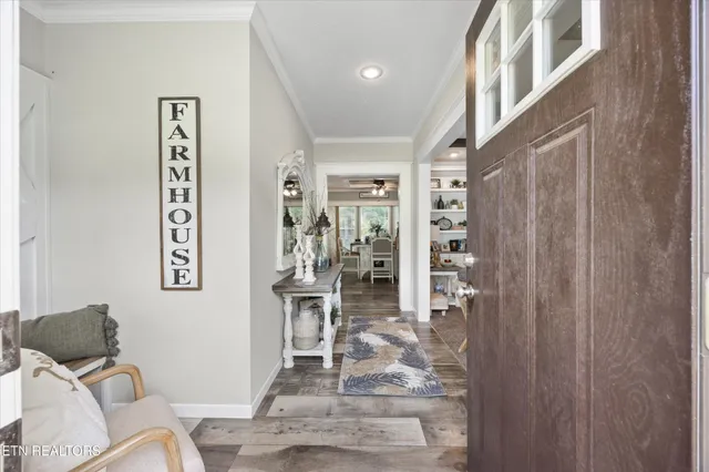 a living room with furniture a flat screen tv and a floor to ceiling window