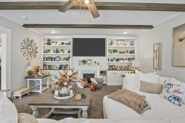 a living room with furniture and a chandelier