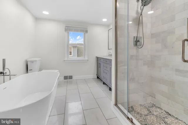 a bathroom with a bathtub and shower