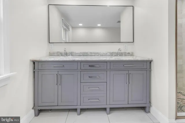 a bathroom with a granite countertop sink and vanity