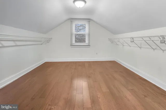 a view of a room with wooden floor and windows