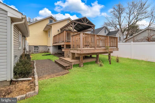 a view of a chair and table in backyard of the house