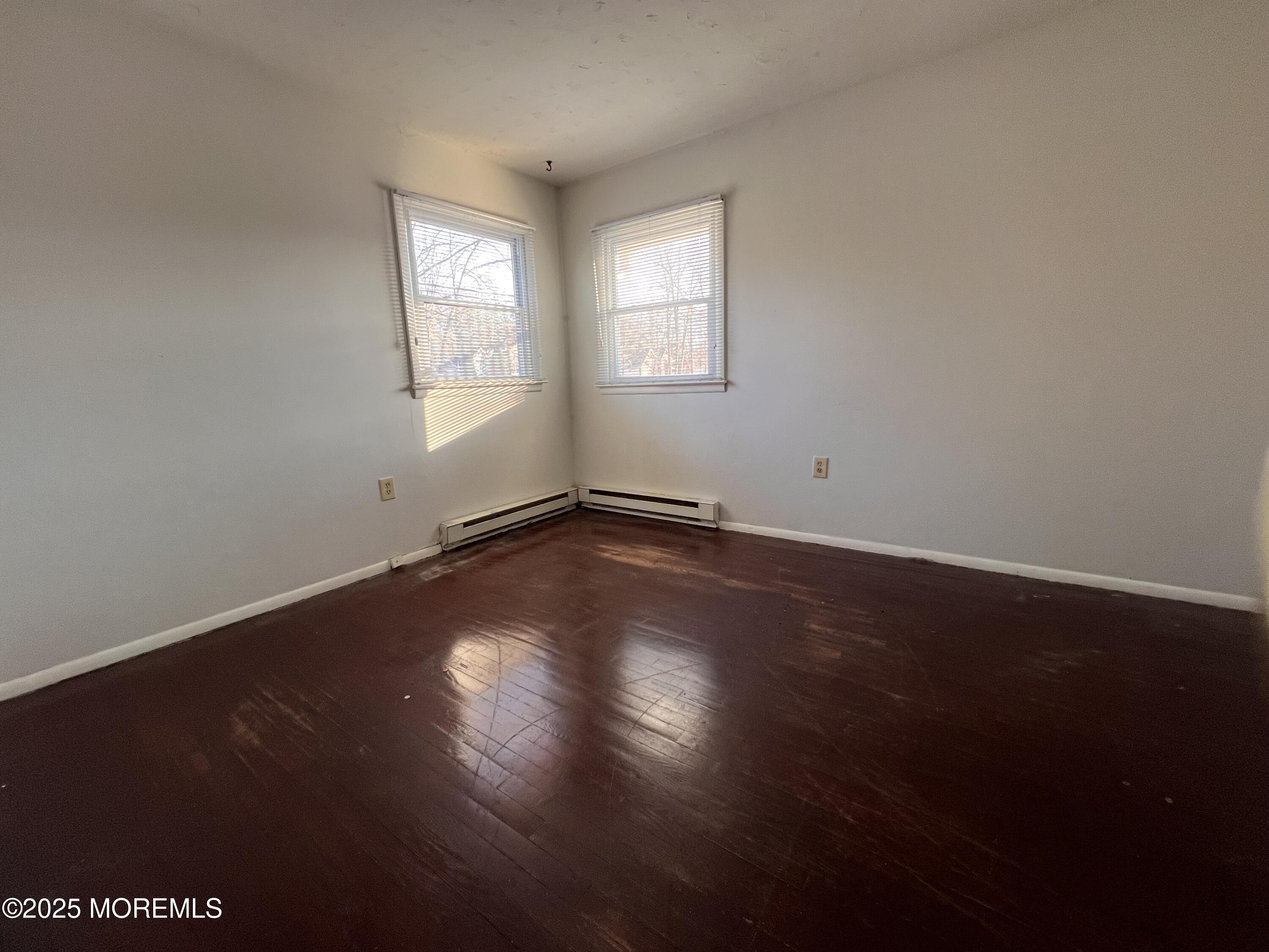17 Afton Road Jackson, NJ 08527 - Photo 3 of 21 an empty room with wooden floor and windows