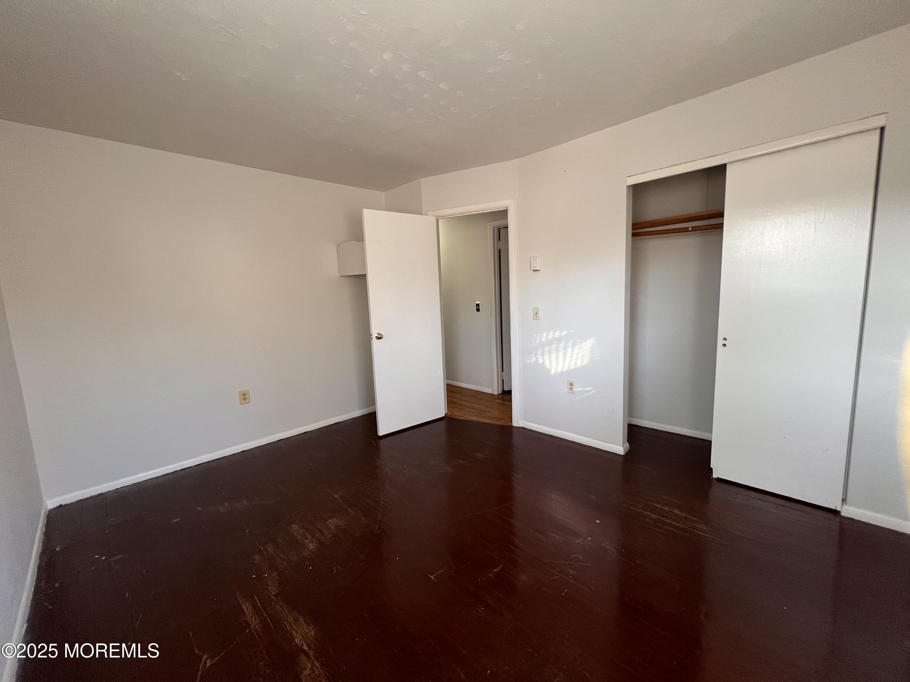 17 Afton Road Jackson, NJ 08527 - Photo 4 of 21 a view of an empty room with wooden floor and closet