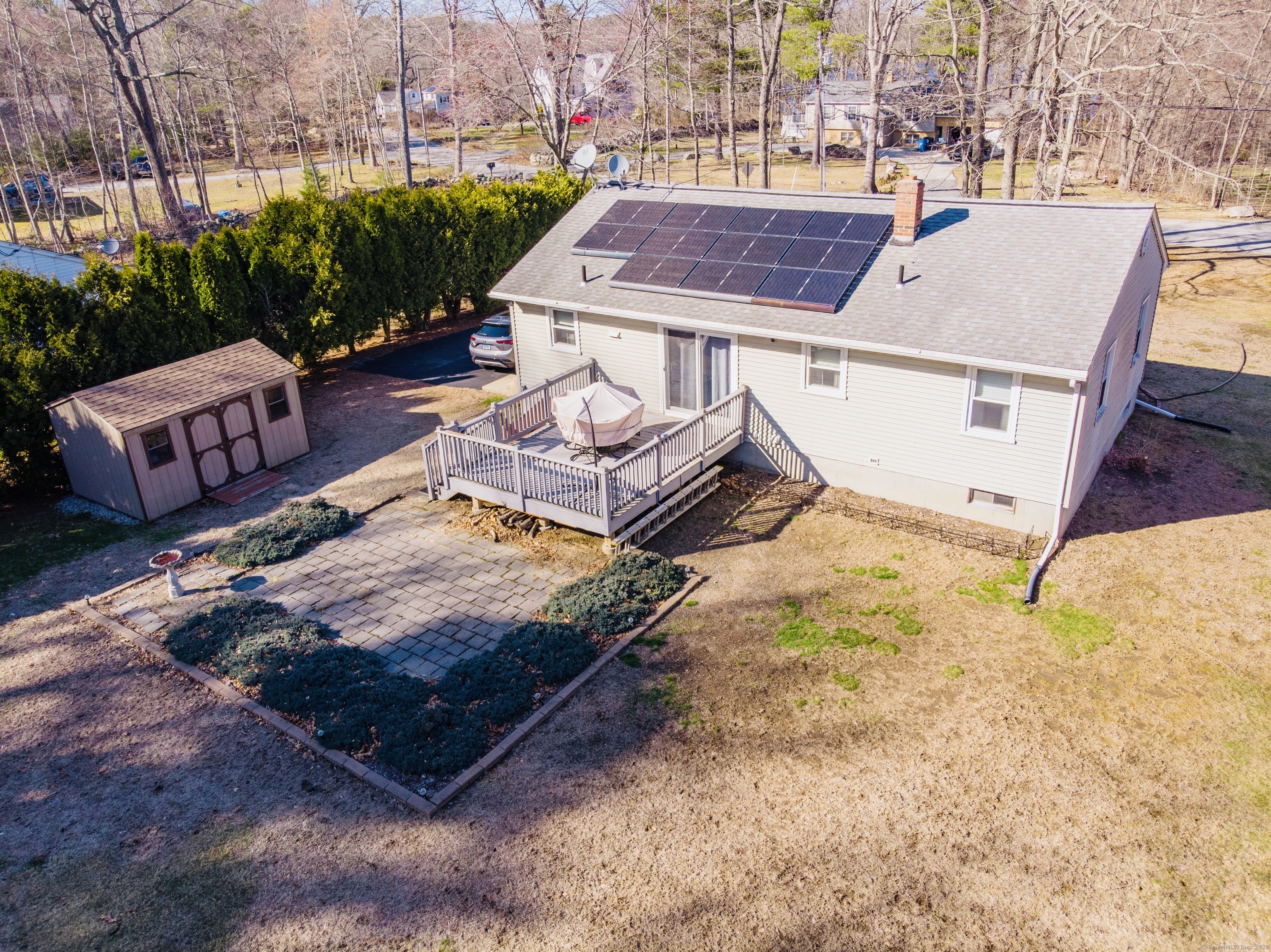 a view of a backyard with plants and patio