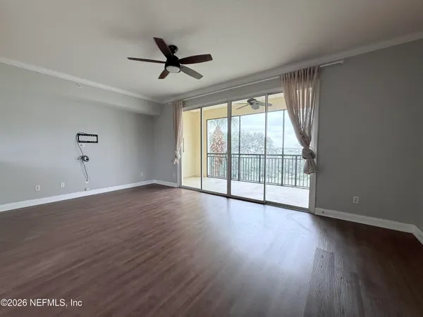 a view of wooden floor and windows in a room