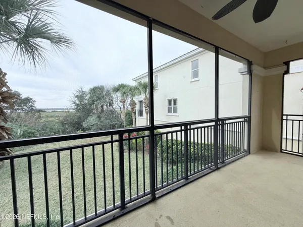 a view of a balcony with floor to ceiling window and wooden floor